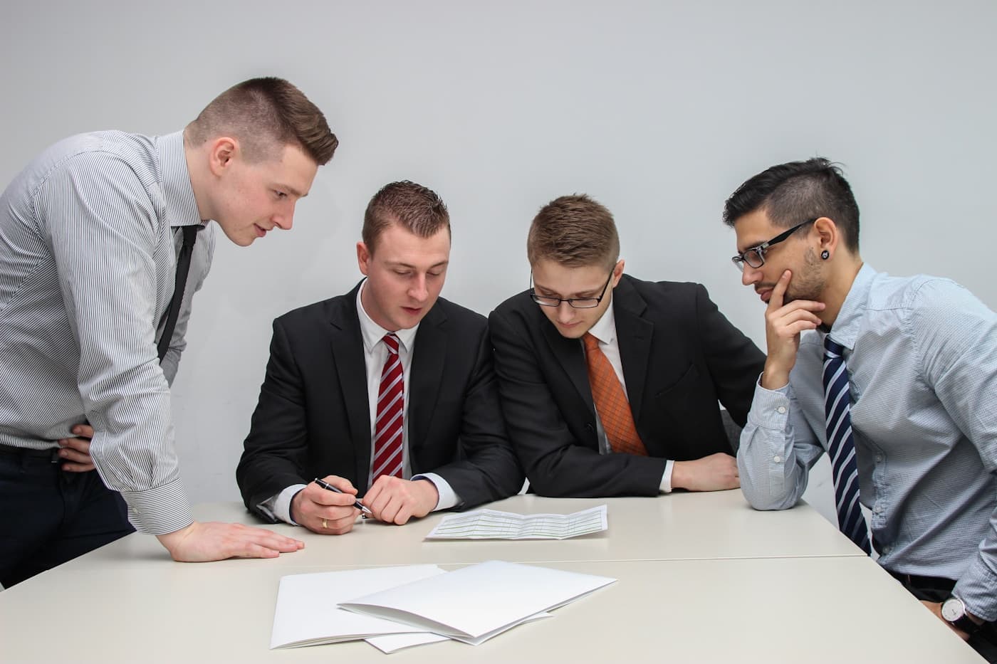 Compliance team reviewing audit evidence documentation at a conference table